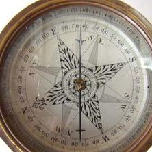 A compass with the center of a star on it.