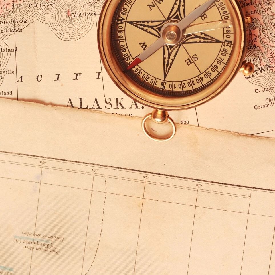 A compass on top of an old map.